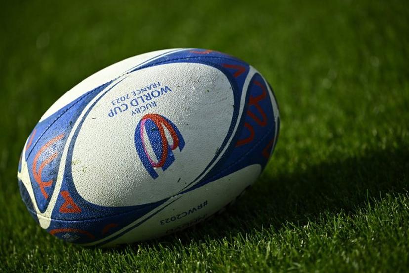 This photograph taken on October 10, 2023, shows an official Rugby World Cup ball displayed on the pitch during a training session at the French National Institute of Sport, Expertise, and Performance (INSEP), in Paris, as part of the France 2023 Rugby World Cup. New Zealand will meet Ireland for the quarter final 2 match at the Stade de France in Saint-Denis, on the outskirts of Paris, on October 14, 2023. JULIEN DE ROSA / AFP