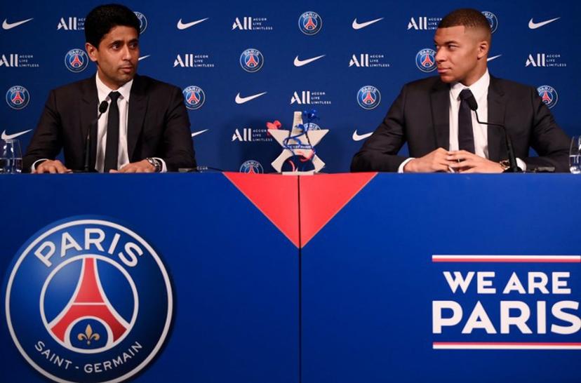 Paris Saint-Germain's CEO Nasser Al-Khelaifi (L) and French forward Kylian Mbappe (R) give a press conference at the Parc des Princes stadium in Paris on May 23, 2022, two days after the club won the Ligue 1 title for a record-equalling tenth time and its superstar striker Mbappe chose to sign a new contract at PSG rather than join Real Madrid.  FRANCK FIFE / AFP