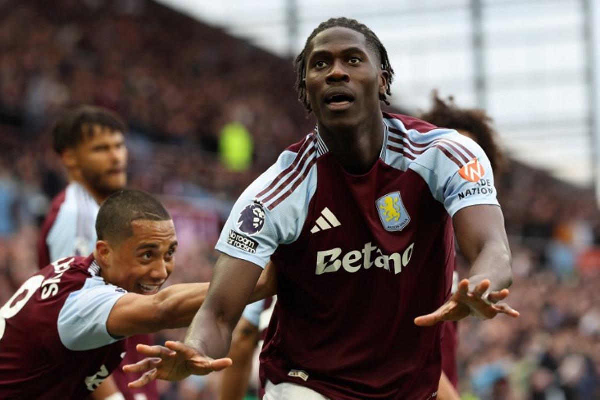 Aston Villa's Belgian defender #24 Amadou Onana (R) celebrates scoring the team's fourth goal during the English Premier League football match between Aston Villa and Newcastle United at Villa Park in Birmingham, central England on April 19, 2025. Darren Staples / AFP
