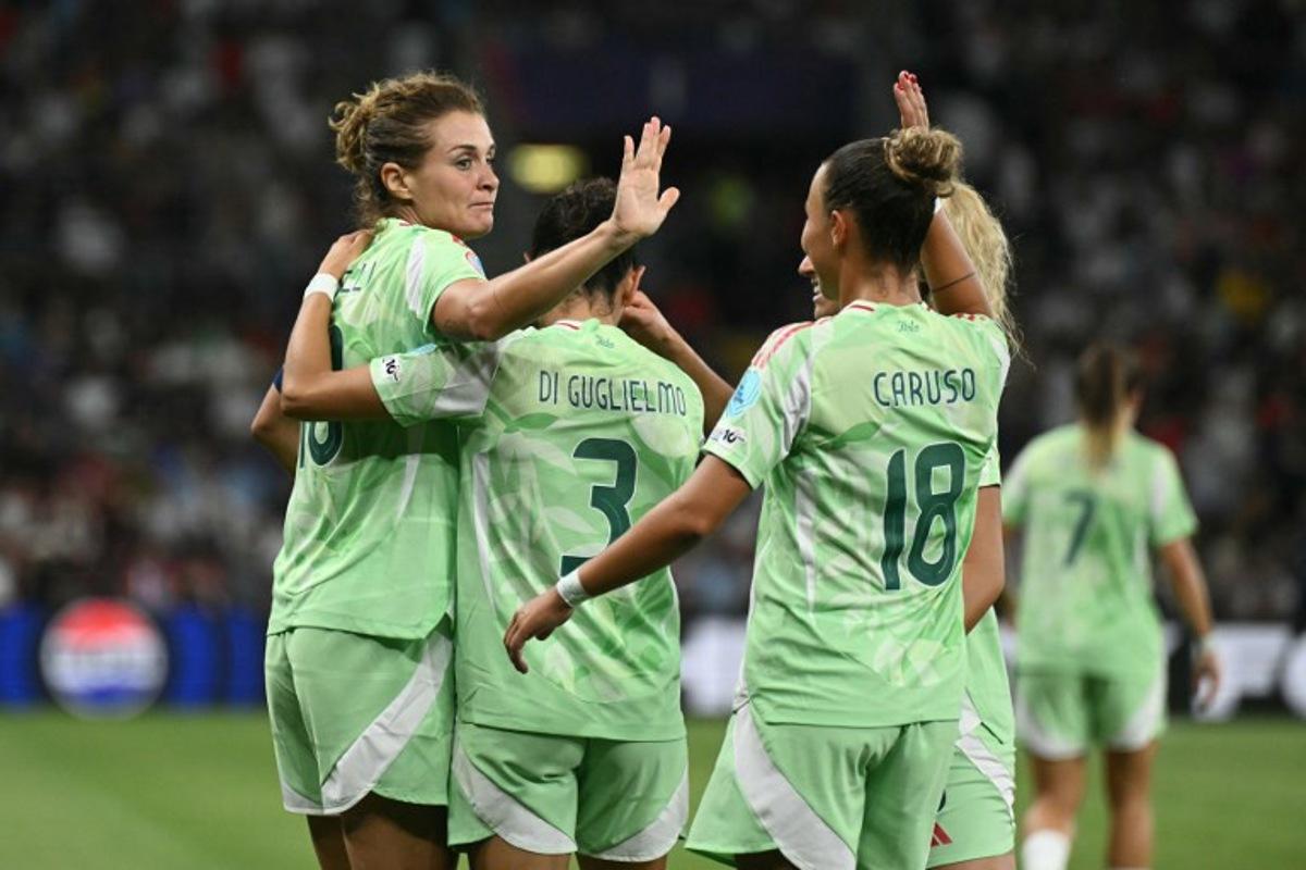 Italy's forward #10 Cristiana Girelli celebrates with teammates Italy's defender #03 Lucia Di Guglielmo, Italy's midfielder #08 Emma Severini and Norway's midfielder #18 Frida Maanum after scoring his team's first goal during the UEFA Women's Euro 2025 quarter-final football match between Norway and Italy at the Stade de Geneve in Geneva, on July 16, 2025.  SEBASTIEN BOZON / AFP