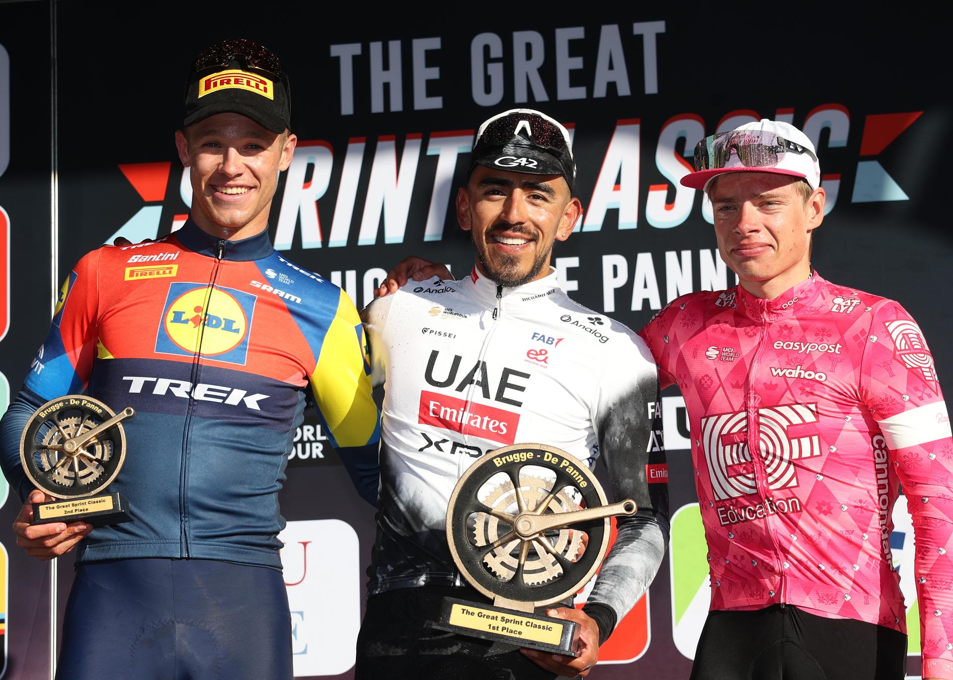 Italian Jonathan Milan of Lidl-Trek, Colombian Juan Sebastian Molano of UAE Team Emirates and Estonian Madis Mihkels of EF Education-EasyPost celebrate on the podium of the 'Classic Brugge-De Panne' men's elite one-day cycling race, 195,6 km from Brugge to De Panne, Wednesday 26 March 2025. BELGA PHOTO KURT DESPLENTER
