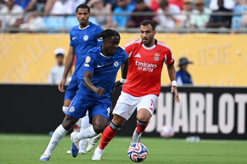 Chelsea's Belgian midfielder #45 Romeo Lavia and Benfica's Greek forward #14 Vangelis Pavlidis fight for the ball during the FIFA Club World Cup 2025 round of 16 football match between Portugal's Benfica and England's Chelsea at the Bank of America Stadium in Charlotte on June 28, 2025.  Federico PARRA / AFP