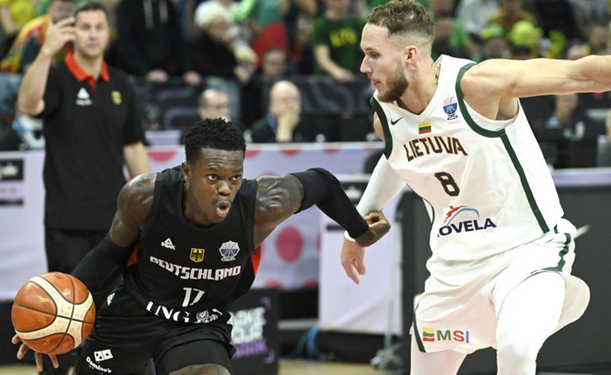 Germany's point guard #17 Dennis Schroder (L) and Lithuania's Tadas Sedekerskis vie for the ball during the basketball FIBA EuroBasket 2025 group B match between Lithuania and Germany in Tampere, Finland, on August 30, 2025.   Heikki Saukkomaa / Lehtikuva / AFP