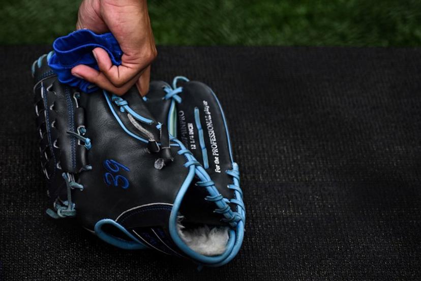 St. Louis Cardinals pitcher Miles Mikolas picks up his glove during the practise prior to the first of the two-game, 2023 major league baseball London Series between the St. Louis Cardinals and the Chicago Cubs at London Stadium in east London on June 24, 2023.  Ben Stansall / AFP