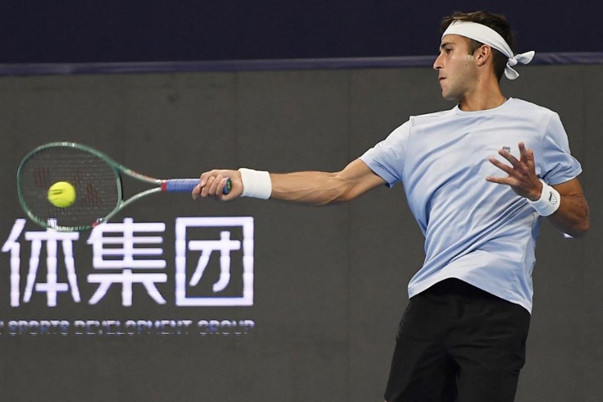 Argentina's Tomas Martin Etcheverry hits a return to France's Corentin Moutet during their men's singles quarter-final match at the Hangzhou Open tennis tournament in Hangzhou, in China's eastern Zhejiang province on September 21, 2025.  STR / AFP