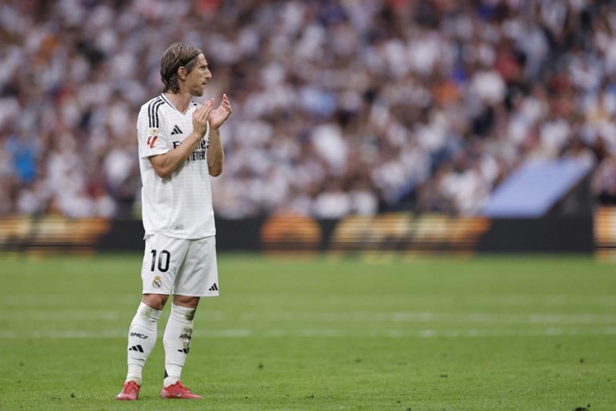 Real Madrid's Croatian midfielder #10 Luka Modric claps during the Spanish league football match between Real Madrid CF and Real Sociedad at Santiago Bernabeu Stadium in Madrid on May 24, 2025.  OSCAR DEL POZO / AFP