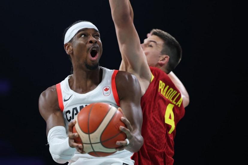 Canada's #02 Shai Gilgeous-Alexander (L) challenges Spain's #04 Jaime Pradilla in the men's preliminary round group A basketball match between Canada and Spain during the Paris 2024 Olympic Games at the Pierre-Mauroy stadium in Villeneuve-d'Ascq, northern France, on August 2, 2024.  Thomas COEX / AFP