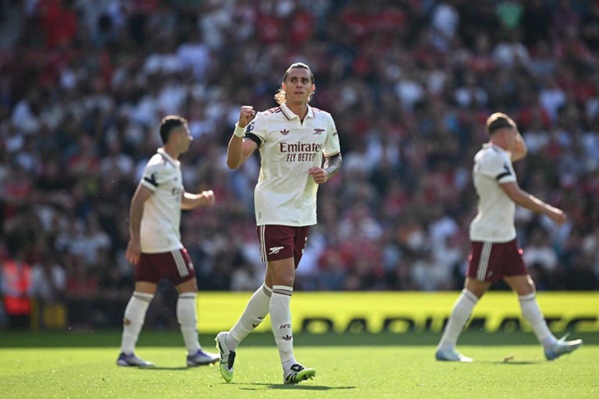 Arsenal's Italian defender #33 Riccardo Calafiori (C) celebrates scoring the opening goal during the English Premier League football match between Manchester United and Arsenal at Old Trafford in Manchester, north west England, on August 17, 2025.  Paul ELLIS / AFP