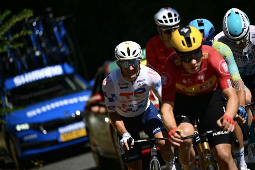 Team TotalEnergies' French rider Mathieu Burgaudeau (L) and Uno-X Mobility team's Norwegian rider Jonas Abrahamsen cycle in a breakaway during the 11th stage of the 112th edition of the Tour de France cycling race, 156.8 km starting and finishing in Toulouse, southwestern France, on July 16, 2025.  Loic VENANCE / AFP