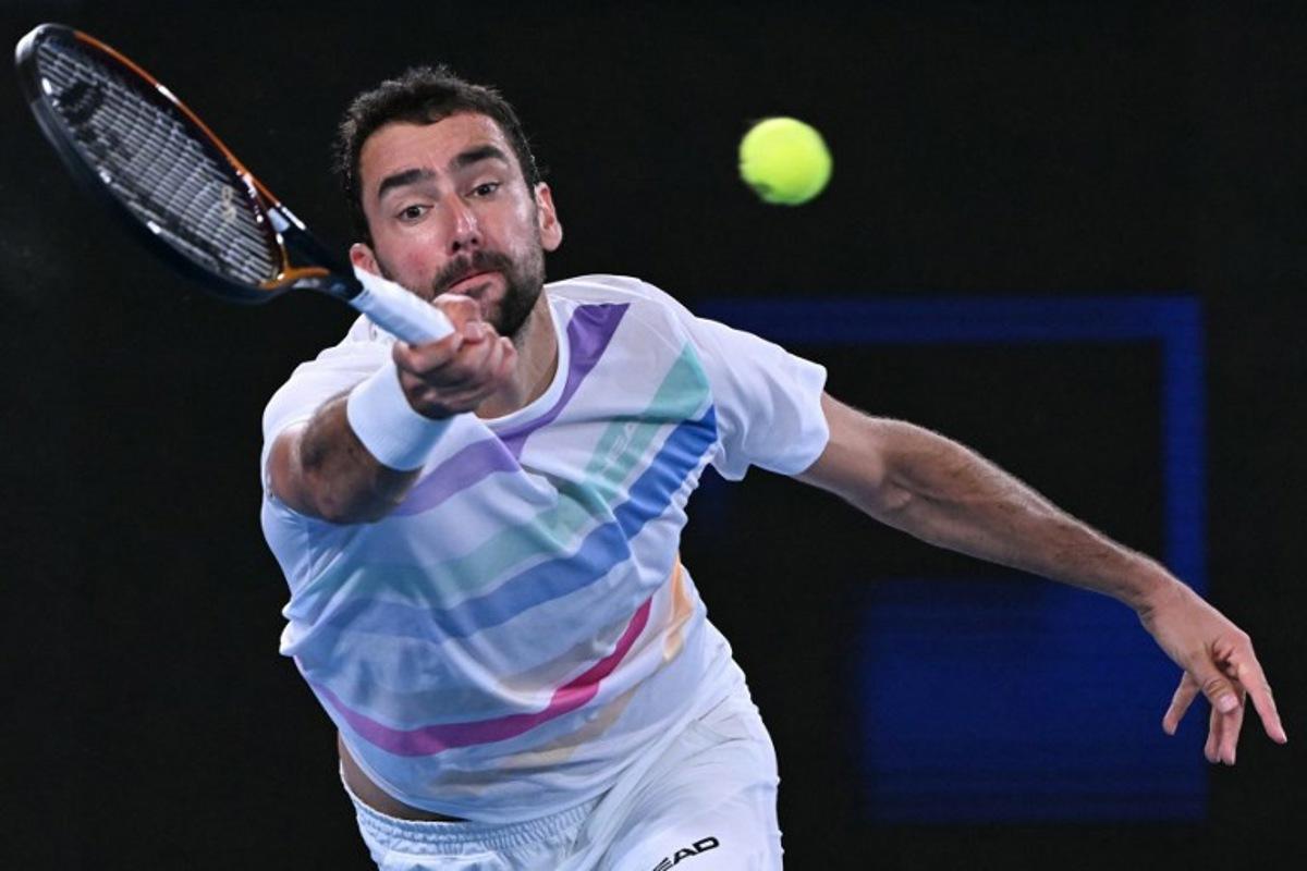 Croatia's Marin Cilic hits a shot against Norway's Casper Ruud during their men's singles match on day seven of the Australian Open tennis tournament in Melbourne on January 24, 2026.  WILLIAM WEST / AFP