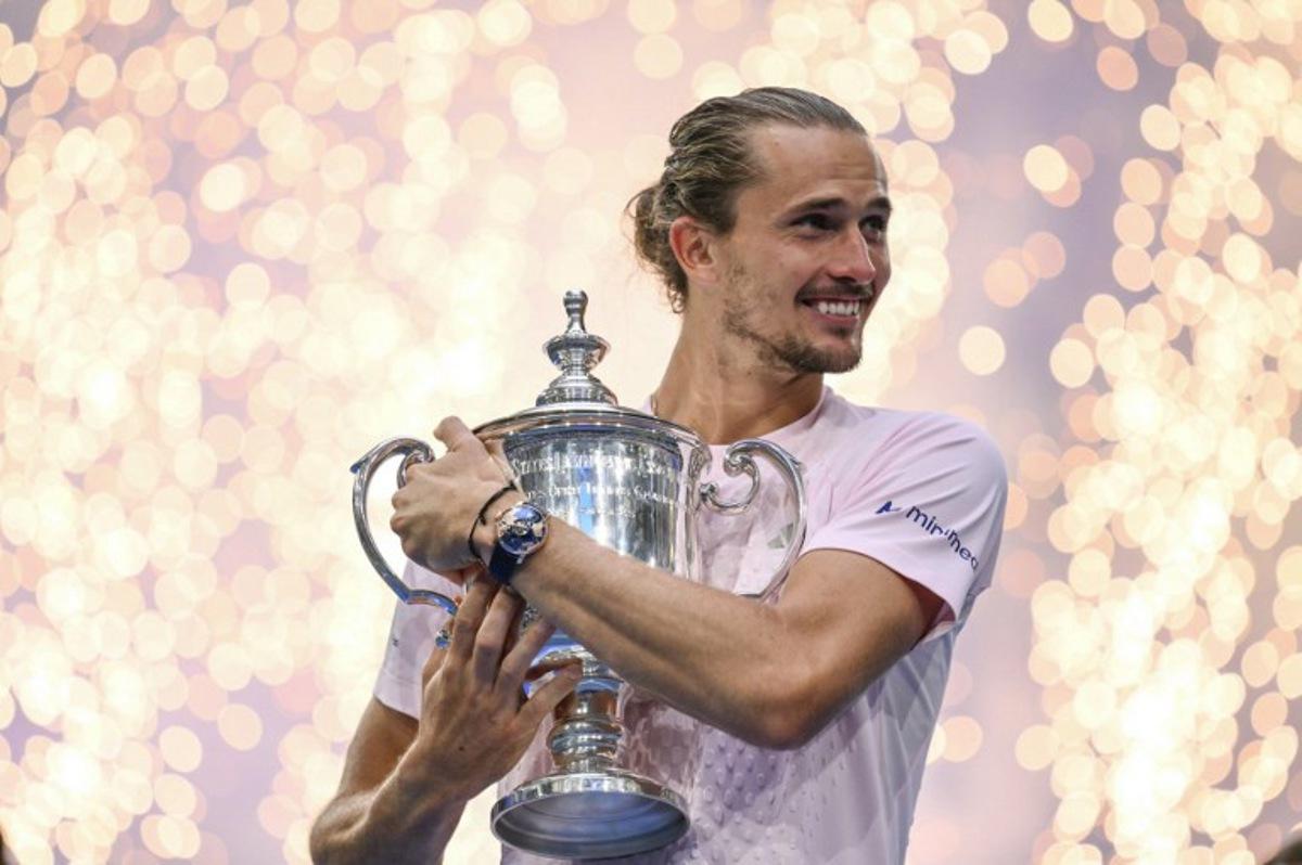 Germany's Alexander Zverev hugs the trophy after defeating USA's Ben Shelton in the men's singles final tennis match on day fifteen of the US Open tennis tournament at the USTA Billie Jean King National Tennis Center in New York on September 13, 2026.  ANGELA WEISS / AFP