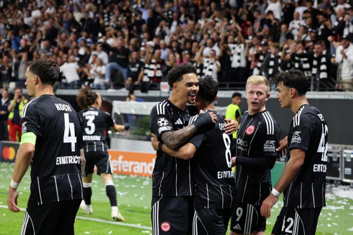 Frankfurt's Turkish forward #42 Can Uzun (R), Frankfurt's German forward #09 Jonathan Burkardt (2nd R) and team mates celebrate during the UEFA Champions League league phase day 1 football match between Eintracht Frankfurt and Galatasaray in Frankfurt, western Germany on September 18, 2025.  Daniel ROLAND / AFP