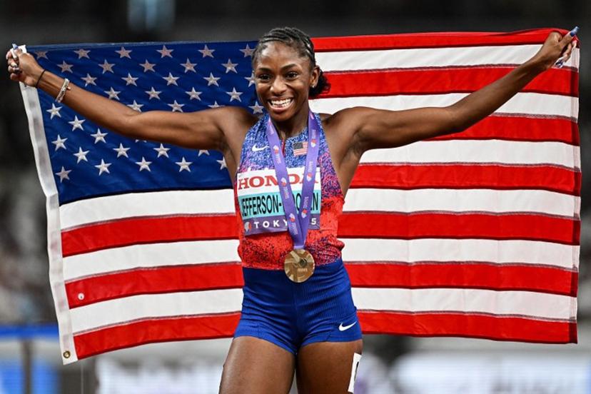 US' athlete Melissa Jefferson-Wooden celebrates with her country's flag after winning the women's 100m final during the World Athletics Championships in Tokyo on September 14, 2025.  Jewel SAMAD / AFP