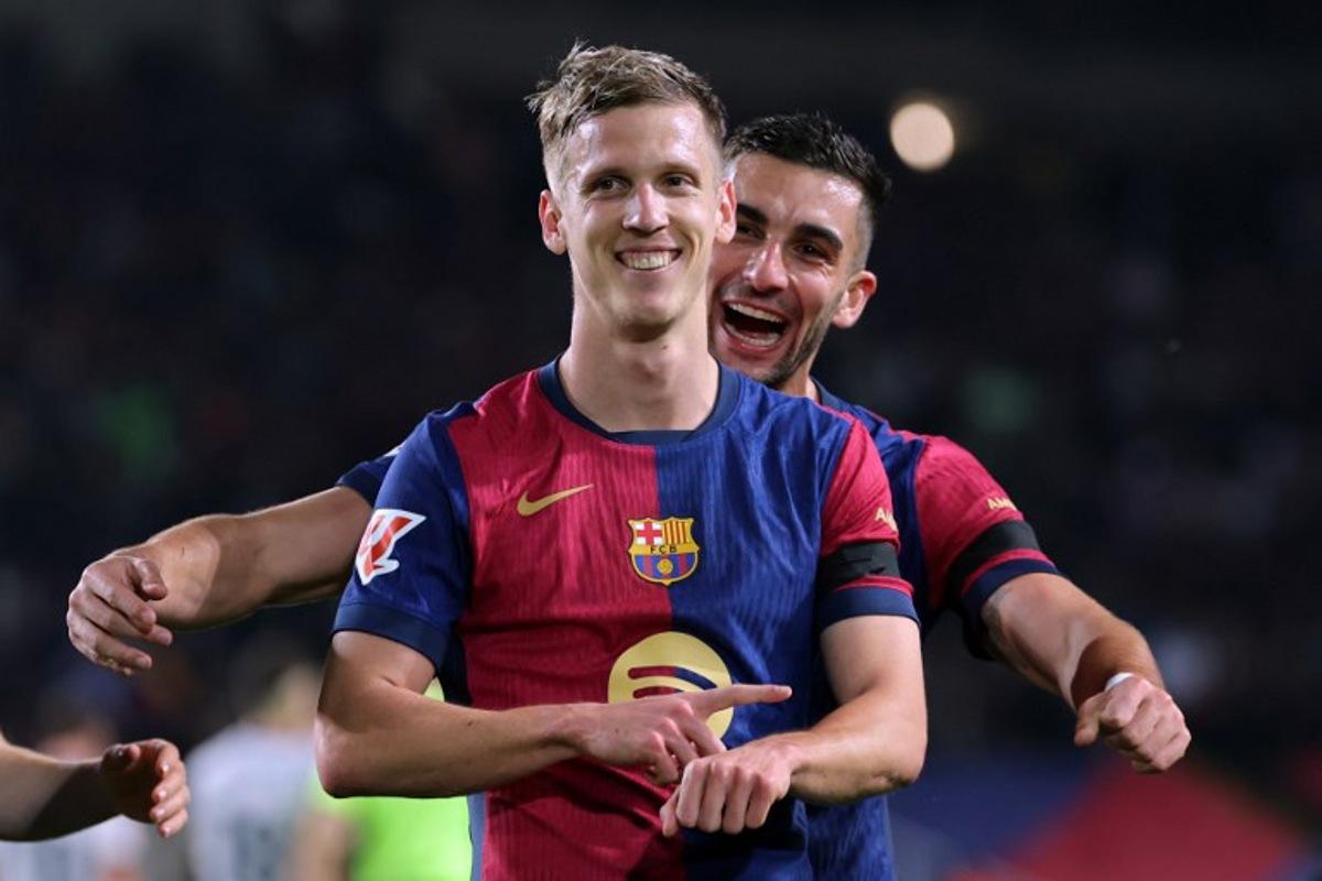 Barcelona's Spanish forward #20 Daniel Olmo (Front) celebrates with his teammate Barcelona's Spanish forward #07 Ferran Torres after scoring a penalty kick and his team's second goal during the Spanish league football match between FC Barcelona and CA Osasuna at Estadi Olimpic Lluis Companys in Barcelona on March 27, 2025.  LLUIS GENE / AFP