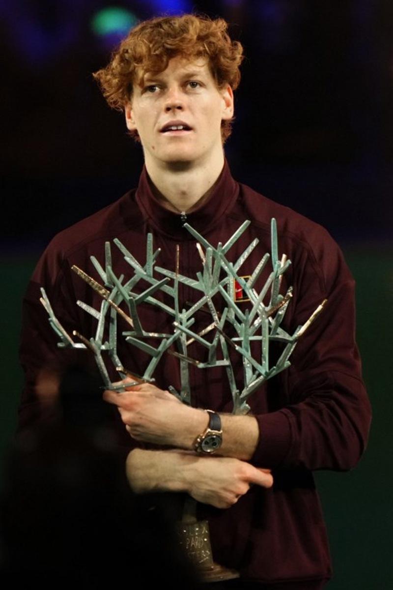 Italy's Jannik Sinner celebrates with the trophy after winning the men's singles final match of the Paris ATP Masters 1000 tennis tournament against Canada's Felix Auger-Aliassime at the Paris La Défense Arena in Nanterre, on the outskirts of Paris, on November 2, 2025.  Dimitar DILKOFF / AFP