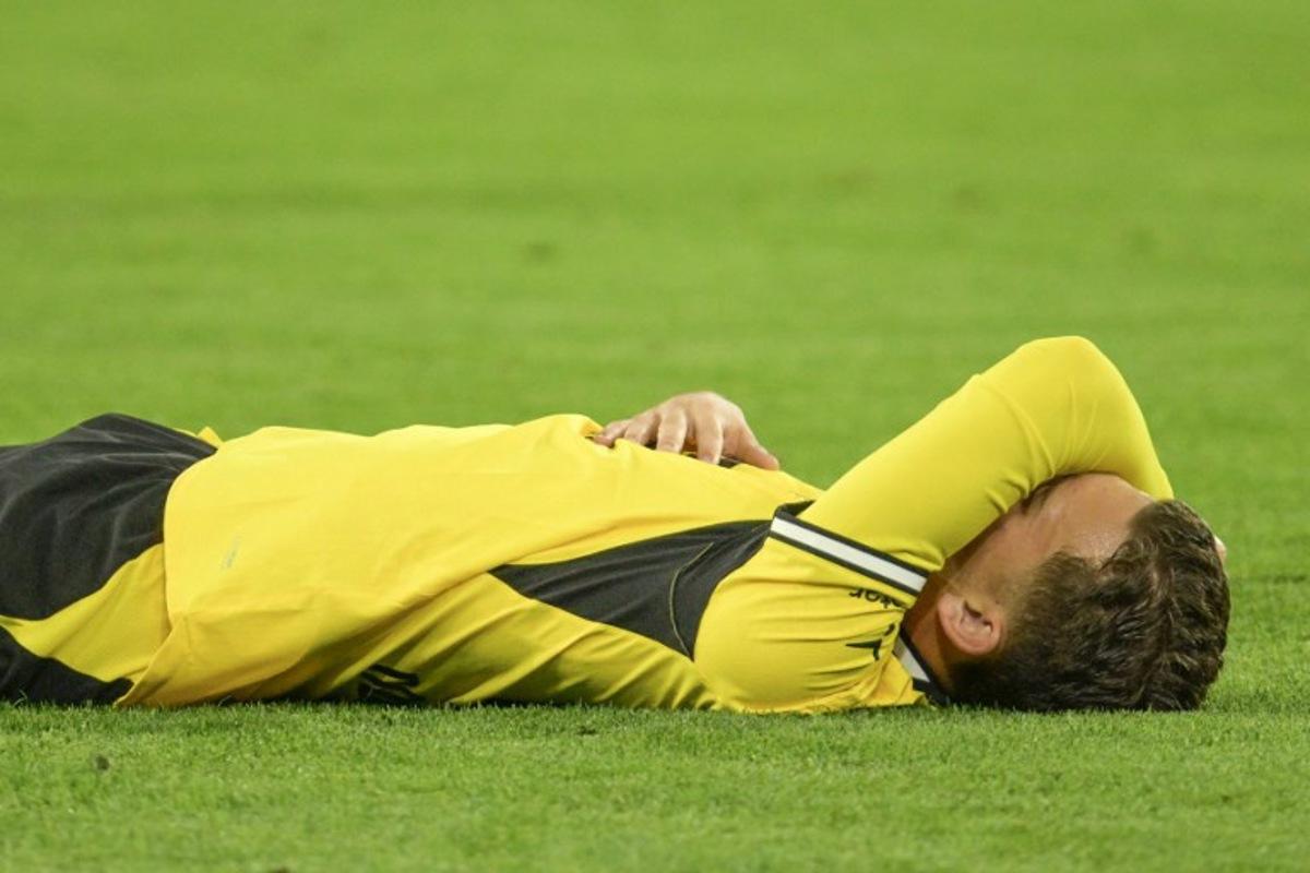 Borussia Dortmund's Greek midfielder #19 Konstantinos Karetsas lays on the pitch after injury during the UEFA Champions League - League phase, Matchday 1 - football match between BVB Borussia Dortmund and Villarreal CF in Dortmund, western Germany, on September 8, 2026.  Sascha Schuermann / AFP