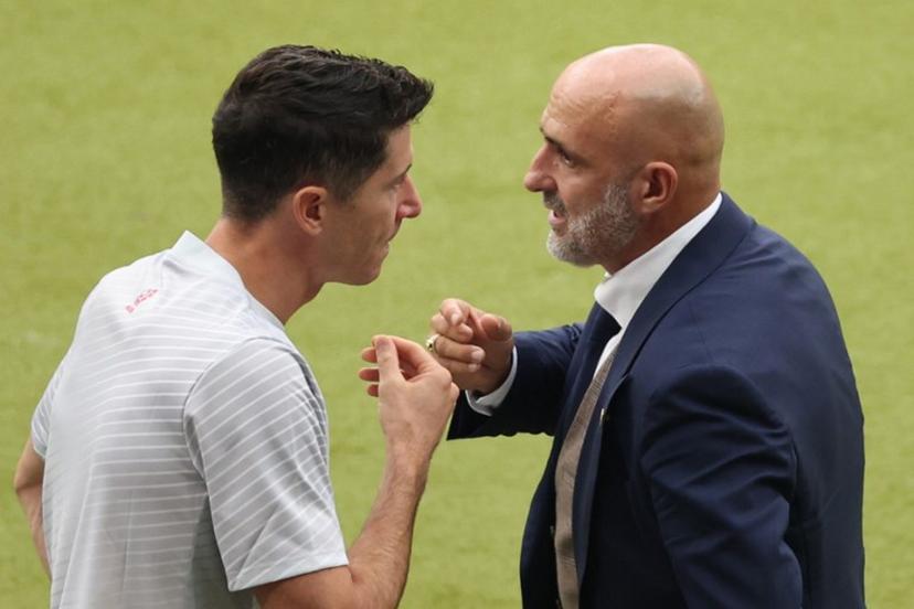 Poland's head coach Michal Probierz speaks with Poland's forward #09 Robert Lewandowski during the UEFA Euro 2024 Group D football match between Poland and Austria at the Olympiastadion in Berlin on June 21, 2024.  Ronny HARTMANN / AFP