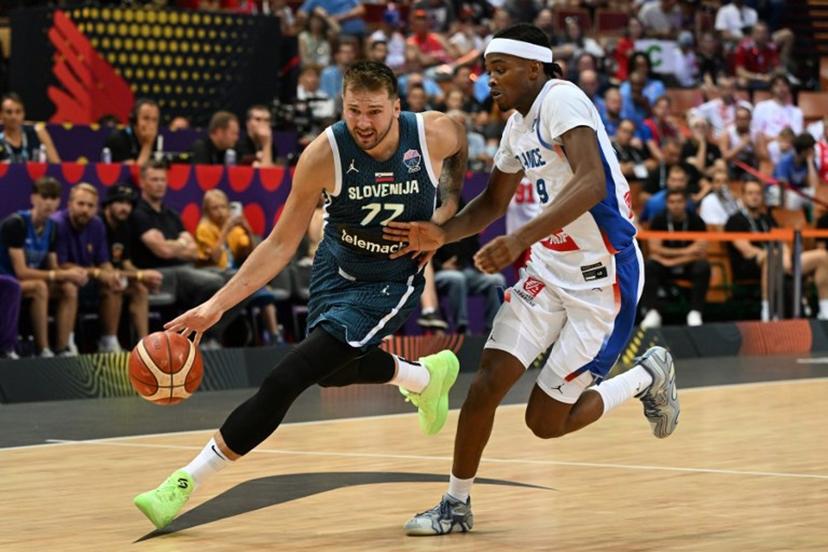 Slovenia's guard #77 Luka Doncic (L) and France's shooting guard #99 Bilal Coulibaly (R) vie during the FIBA EuroBasket 2025 Group D basketball match between France and Slovenia at the Spodek Arena in Katowice, Poland on August 30, 2025.  Sergei GAPON / AFP