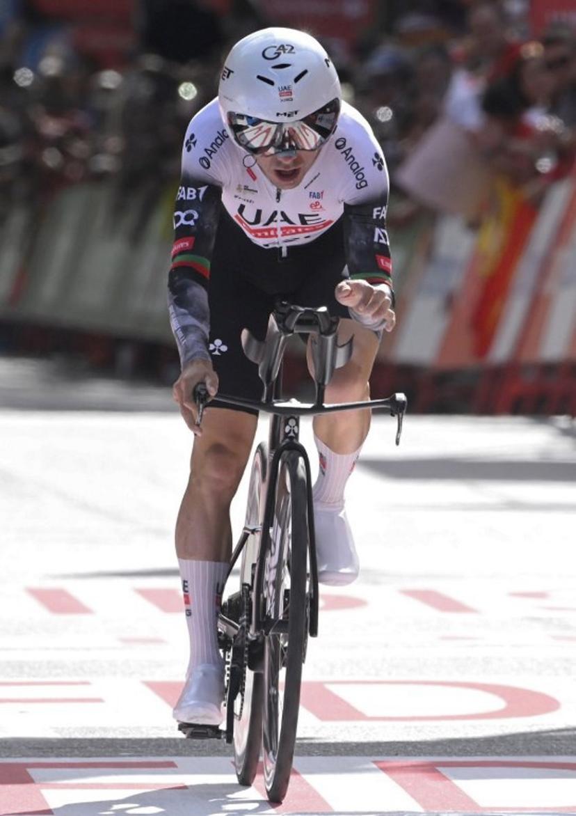 Team UAE's Portuguese rider Joao Almeida crosses the finish line of the 18th stage of the Vuelta a Espana, a 26 km race against the clock between Valladolid and Valladolid, on September 11, 2025.    Miguel RIOPA / AFP