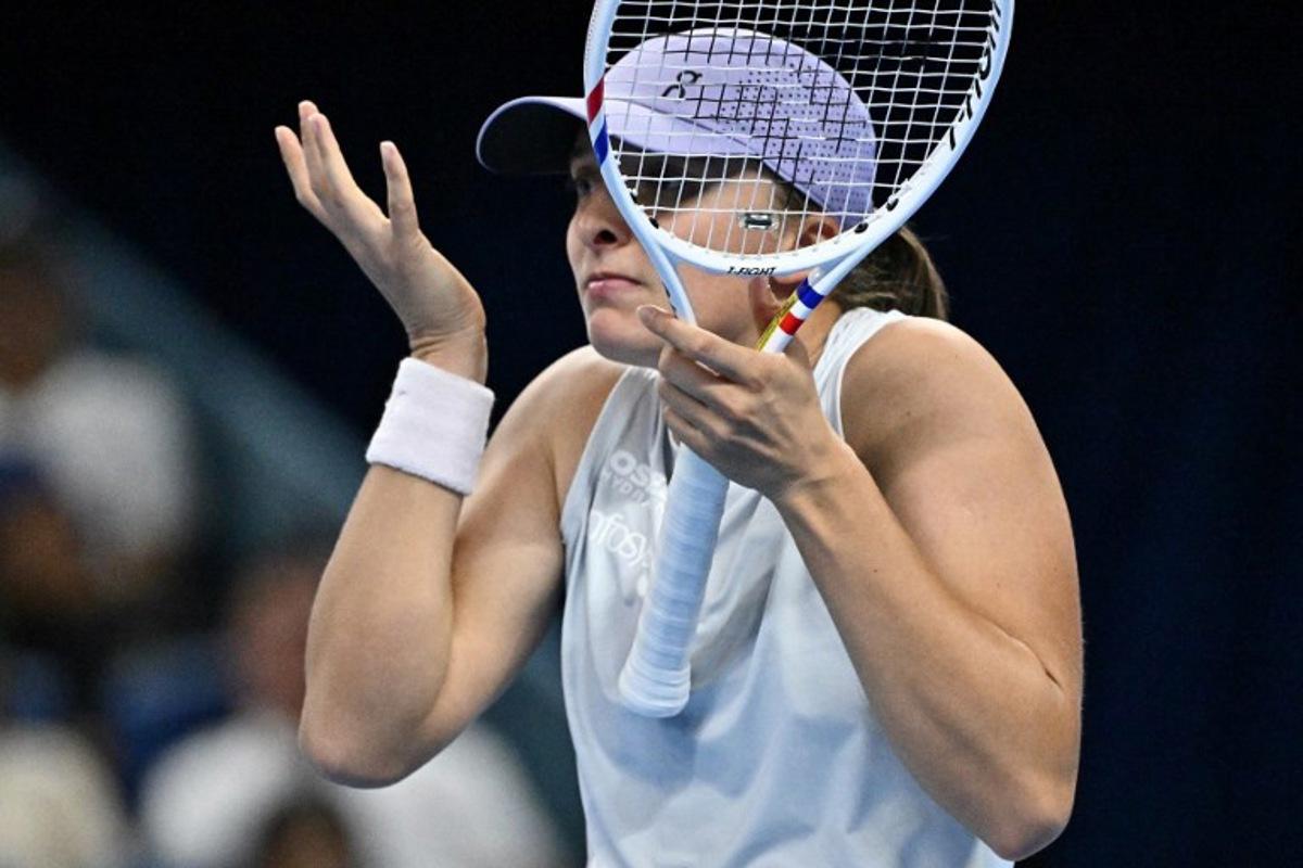 Poland's Iga Swiatek reacts during her women's singles match against USA's Emma Navarro at the China Open tennis tournament in Beijing on October 1, 2025.  Pedro Pardo / AFP