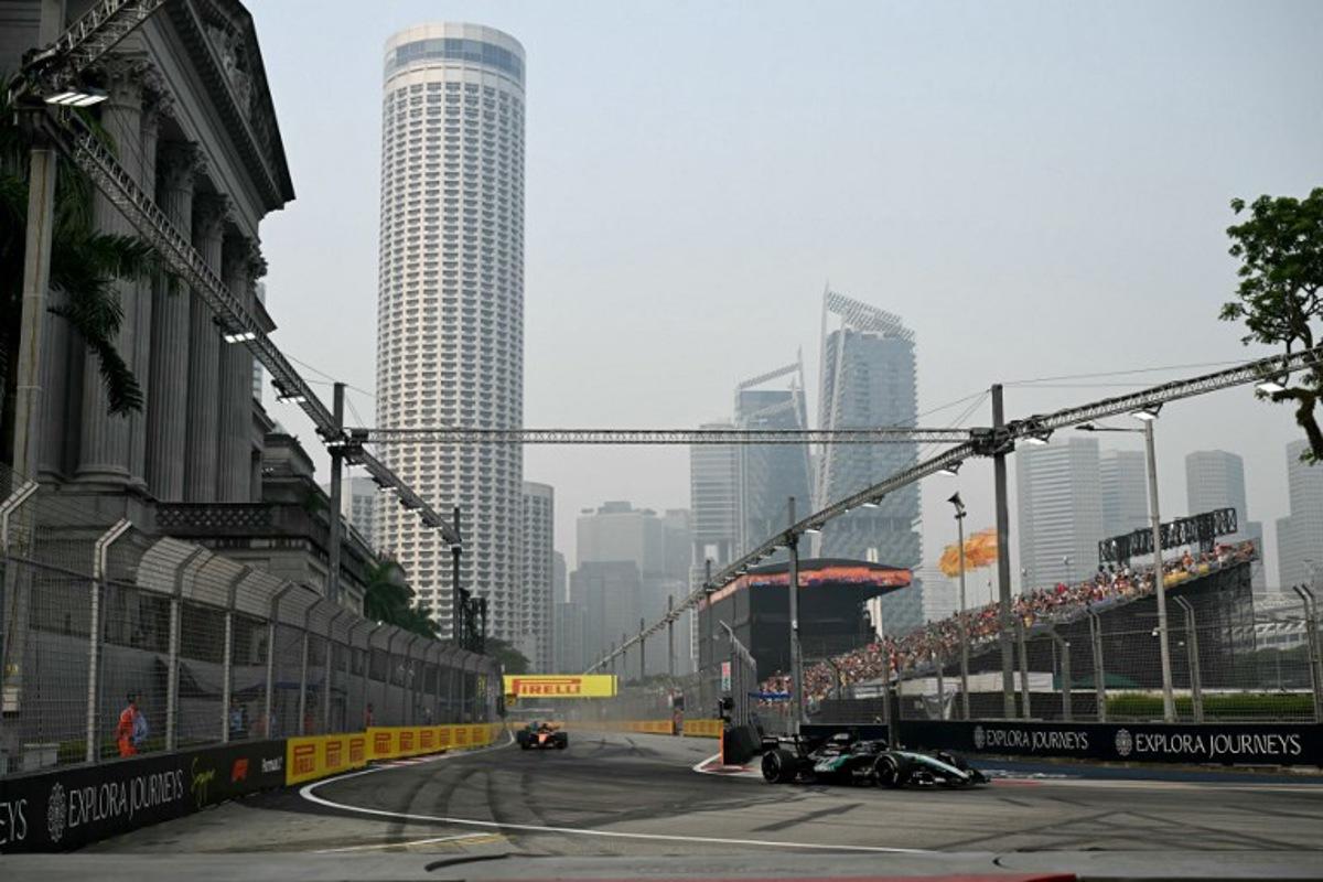 Mercedes' British driver George Russell (R) drives during a practice session ahead of the Formula One Singapore Grand Prix at the Marina Bay Street Circuit in Singapore on October 9, 2026.  Roslan RAHMAN / AFP