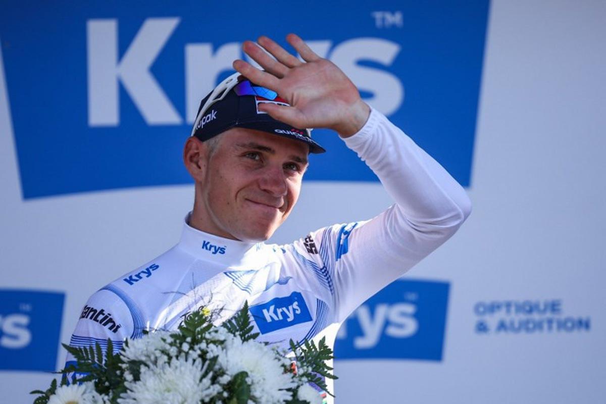Soudal Quick-Step team's Belgian rider Remco Evenepoel celebrates on the podium with the best young rider's white jersey after the 13th stage of the 112th edition of the Tour de France cycling race, 10.9 km individual time trial between Loudenvielle and Peyragudes, in the Pyrenees mountains of southwestern France, on July 18, 2025.  Anne-Christine POUJOULAT / AFP