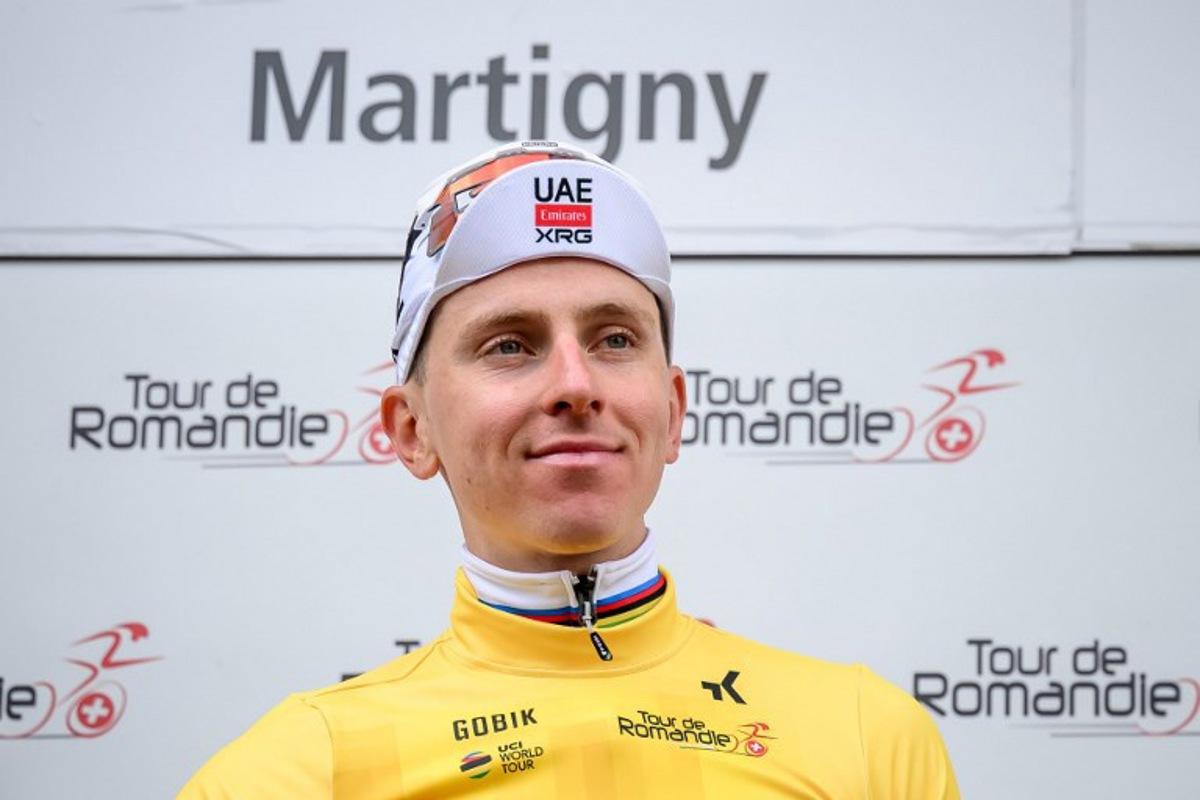 UAE Team Emirates-XRG's Slovenian rider Tadej Pogacar wearing the overall leader's yellow jersey smiles on the podium of the first stage of the Tour of Romandie UCI cycling World tour, a 171.2 km loop from Martigny-Ville to Martigny-Ville, in Martigny, on April 29, 2026.  Fabrice COFFRINI / AFP