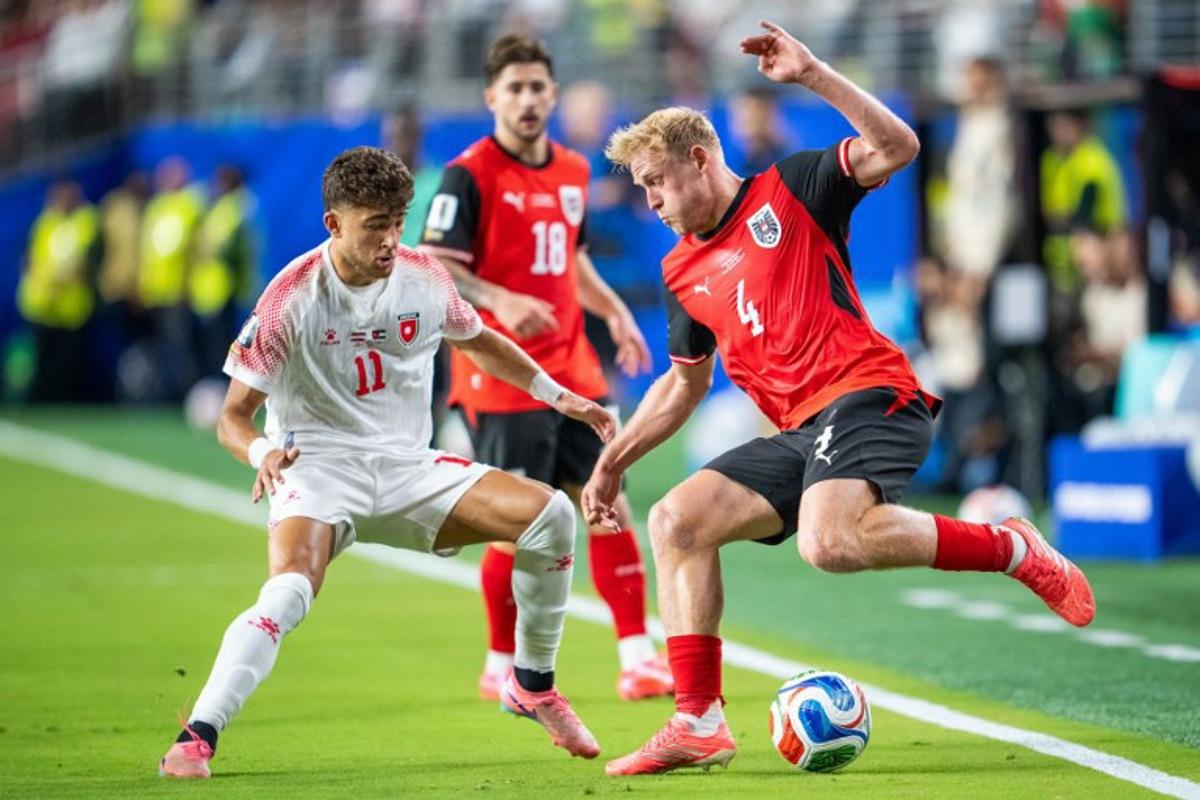 Austria's midfielder #04 Xaver Schlager and Jordan's forward #11 Odeh Fakhoury fight for the ball during the 2026 World Cup Group J football match between Austria and Jordan at the San Francisco Bay Area Stadium in Santa Clara, on June 16, 2026.   GEORG HOCHMUTH / APA / AFP
