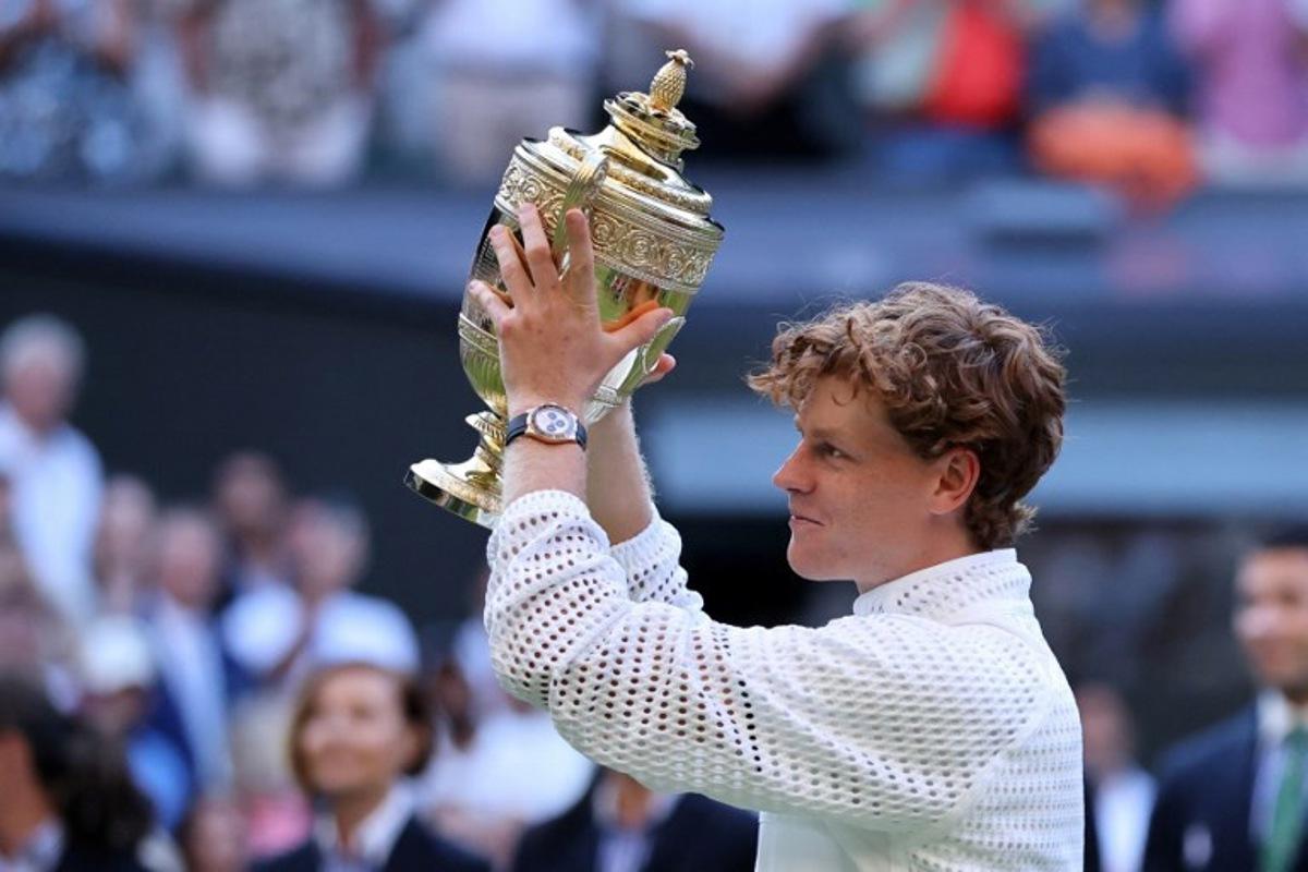 Italy's Jannik Sinner poses with the Gentleman's Singles trophy after his victory against Germany's Alexander Zverev at the end of their men's singles final tennis match on the last day of the 2026 Wimbledon Championships at The All England Lawn Tennis and Croquet Club in Wimbledon, southwest London, on July 12, 2026.  Henry NICHOLLS / AFP