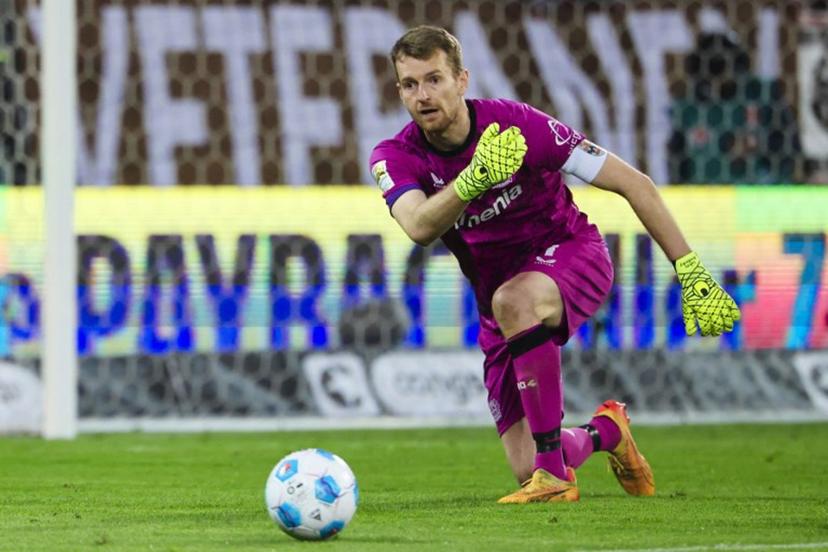 Bayer Leverkusen's Finnish goalkeeper #01 Lukas Hradecky passes the ball during the German first division Bundesliga football match between FC St Pauli and Bayer 04 Leverkusen in Hamburg, northern Germany on April 20, 2025.  FRANK MOLTER / AFP