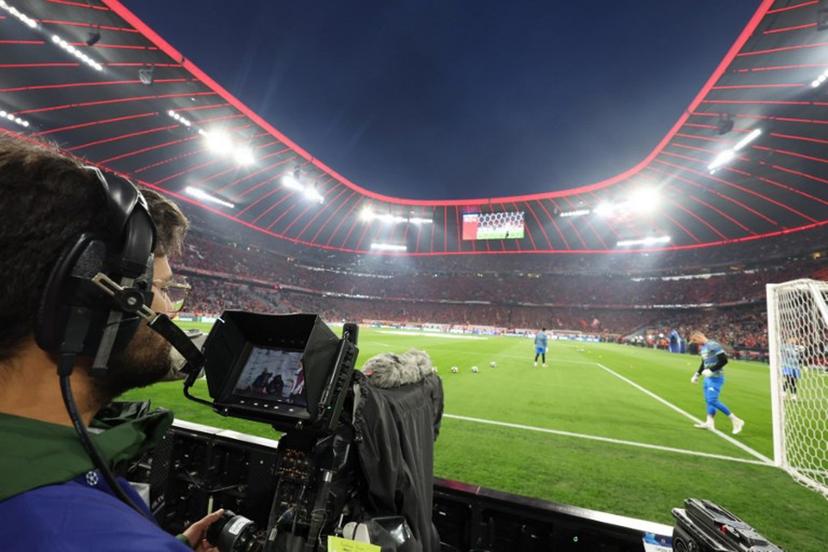 A cameraman looks at the screen of his camera from the sideline prior to the start of the UEFA Champions League quarter-final second leg football match between FC Bayern Munich and Real Madrid in Munich, southern Germany, on April 15, 2026.  Karl-Josef HILDENBRAND / AFP