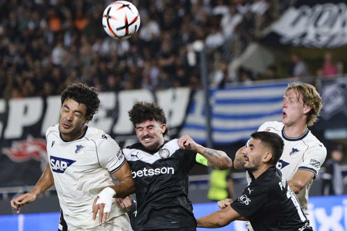 Hoffenheim's Turkish defender #5 Ozan Kabak (L) fights for the ball with OFI's Greek midfielder #14 Thanasis Androutsos (C) and Greek defender #15 Achilleas Poungouras during the UEFA Europa League first round football match between OFI Crete FC and TSG 1899 Hoffenheim at Pankritio stadium in Heraklion on September 17, 2026.  Costas Metaxakis / AFP