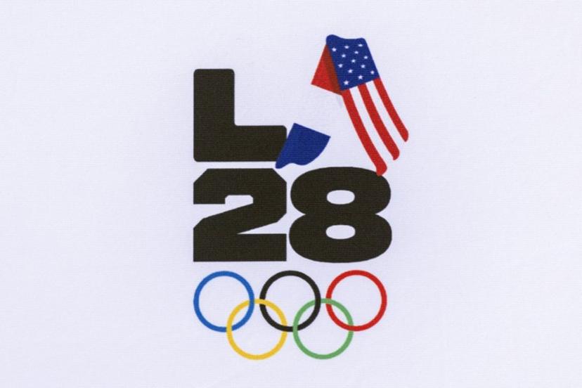 A LA28 (Los Angeles 2028) logo is pictured with French and US national flags during the event celebrating the arrival of the Olympic flag at Los Angeles International Airport (LAX) in Los Angeles, on August 12, 2024.  Los Angeles will host the 2028 Summer Olympic Games. The arrival marks the official Olympic Flag's return to Los Angeles for the first time in 40 years. Etienne LAURENT / AFP
