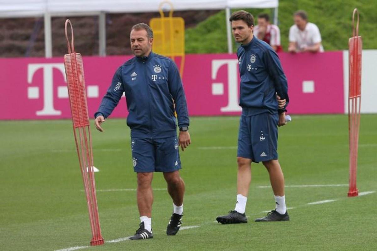 Bayern Munich's German head coach Hansi Flick (L) and and assistant coach analysis Danny Rohl attend a training session during the team's winter camp in Qatar's capital Doha on January 9, 2020.  MUSTAFA ABUMUNES / AFP