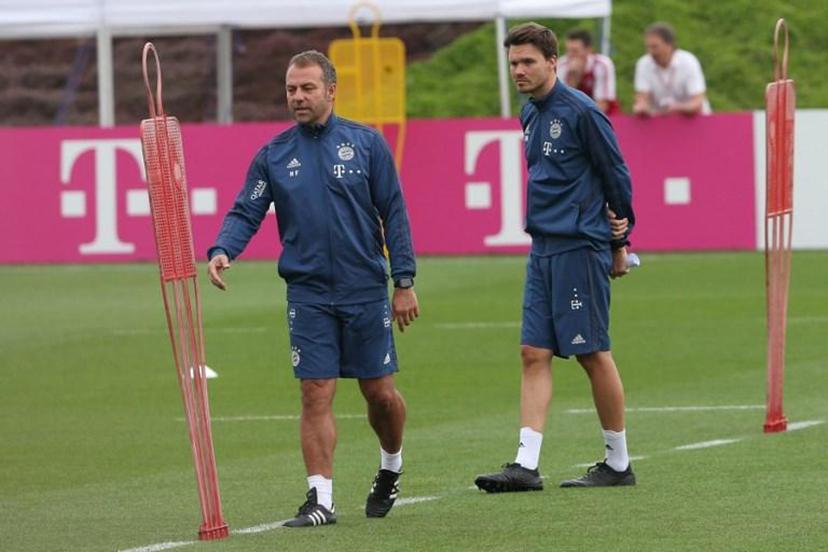 Bayern Munich's German head coach Hansi Flick (L) and and assistant coach analysis Danny Rohl attend a training session during the team's winter camp in Qatar's capital Doha on January 9, 2020.  MUSTAFA ABUMUNES / AFP
