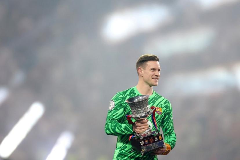 Barcelona's German goalkeeper #1 Marc-Andre Ter Stegen lifts the trophy after winning the Spanish Super Cup final football match between Real Madrid and Barcelona at the King Abdullah Sport City in Jeddah on January 12, 2025.  Haitham AL-SHUKAIRI / AFP