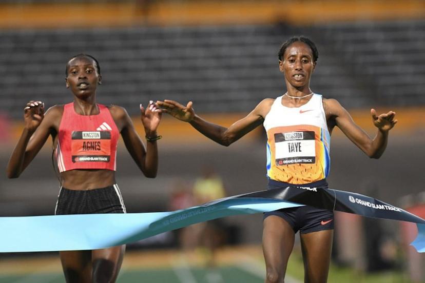 Ethiopia's Ejgayehu Taye (R) of team Nike crosses the finish line in first place ahead of    Kenya's Agnes Jebet Ngetich of team Adidas in the the women's 3000 meters Long Distance during the Grand Slam Track competition at the National Stadium in Kingston, Jamaica on April 4, 2025.  Ricardo Makyn / AFP