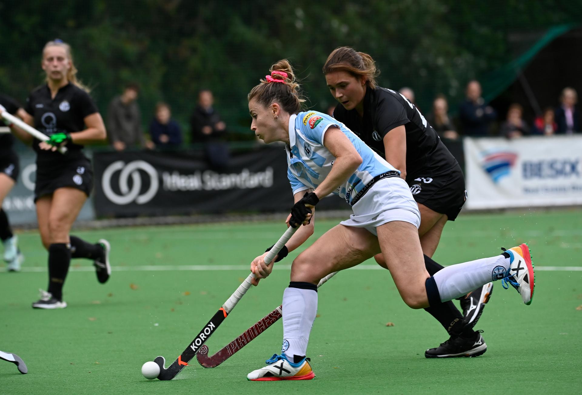 Racing's Charlotte Englebert and Gantoise's Alix Gerniers fight for the ball during a hockey match between Racing and Gantoise, Sunday 16 October 2022 in Ukkel-Uccle, Brussels, on day 8 of the Belgian Women's Hockey League season 2022-2023. BELGA PHOTO JOHN THYS