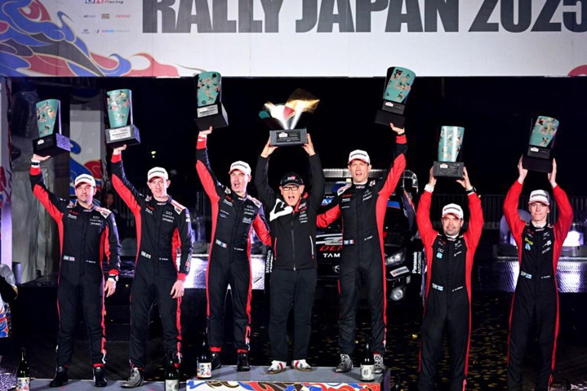 Rally Japan winners Sebastien Ogier (3rd R) and co-driver Vincent Landais (3rd L) of France pose with Toyota Gazoo Racing chairman Akio Toyoda (C) and second placed Britain's Elfyn Evans (2nd L) and his co-driver Scott Martin (L), and third placed Sami Pajari (R) and his co-driver Marko Salminen (2nd R) of Finland during the podium ceremony of the Rally Japan, the 13th round of the FIA World Rally Championships, in Toyota city, Aichi prefecture on November 9, 2025.  Toshifumi KITAMURA / AFP