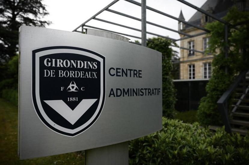 This general view taken on May 19, 2022, shows a sign with a logo in front of the chateau of FC Girondins de Bordeaux at the club's training ground in Le Haillan, near Bordeaux, south-western France.  Philippe LOPEZ / AFP