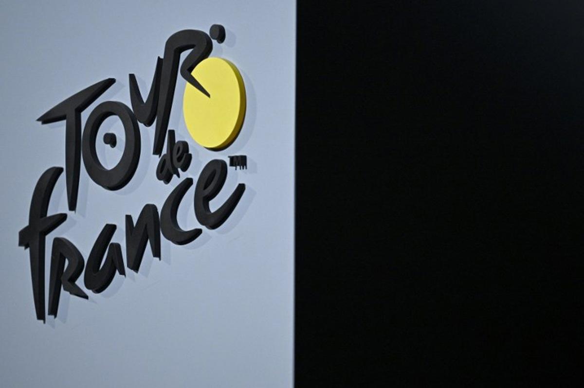The Tour de France cycling race logo is pictured during the official unveiling of both men and women 2025 editions of the Tour de France routes in Paris on October 29, 2024. The Tour de France Men's race will start in Lille, northern France on July 5, 2025 (July 5 - 27) and the women's race (July 26 - August 3) will be launched in Brittany. JULIEN DE ROSA / AFP