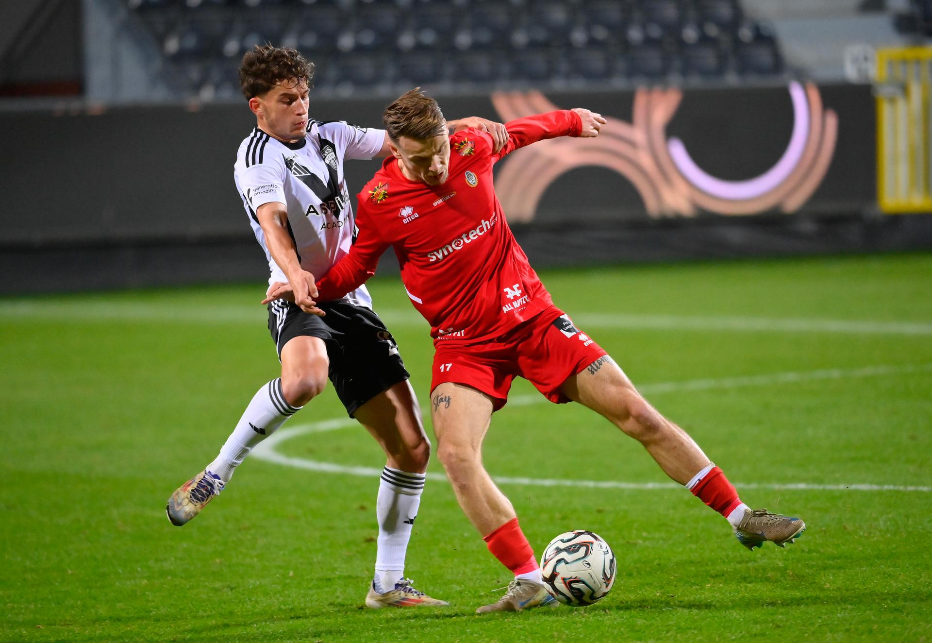 Eupen's Mark Muller and Olympic's Mathieu Cachbach fight for the ball during a soccer game between KAS Eupen and Royal Olympic Charleroi, Sunday 21 December 2025 in Eupen, on day 19 of the 2025-2026 'Challenger Pro League' 1B second division of the Belgian championship. BELGA PHOTO JOHN THYS