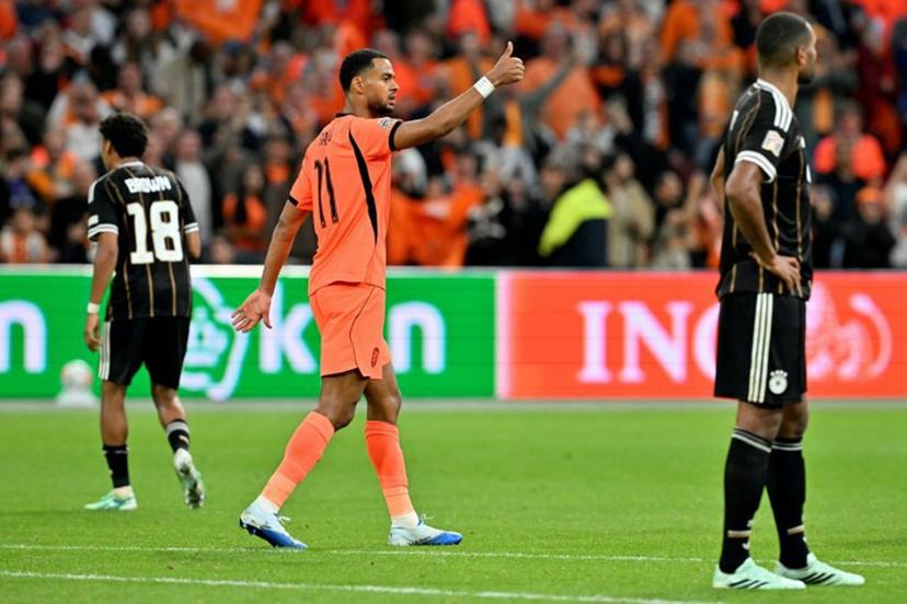 Netherlands' forward #11 Cody Gakpo celebrates after scoring his team's first goal during the UEFA Nations League (League A, Group A2) football match between Netherlands and Germany at Johan Cruijff ArenA in Amsterdam on September 24, 2026.  NICOLAS TUCAT / AFP