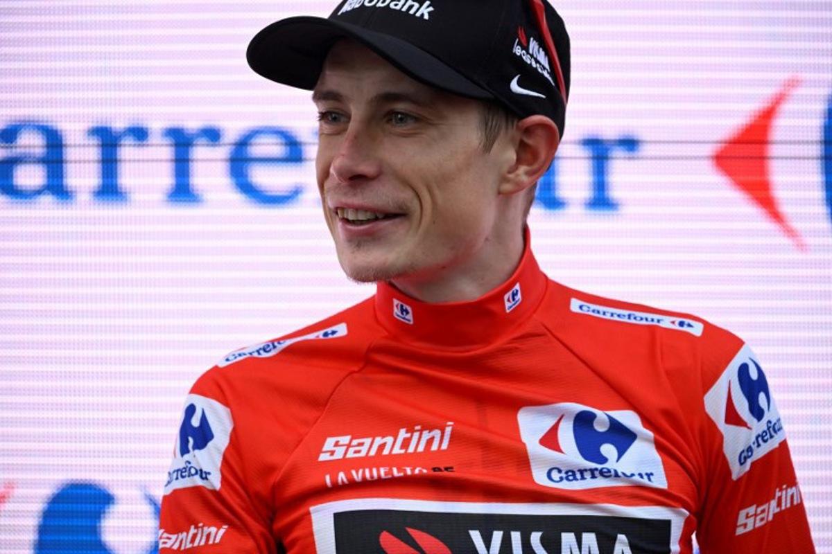 Overall race leader red jersey holder team Visma-Lease a bike's Danish rider Jonas Vingegaard celebrates on the podium of the 19th stage of the Vuelta a Espana, a 159 km race between Rueda and Guijuelo, on September 12, 2025.    Miguel RIOPA / AFP