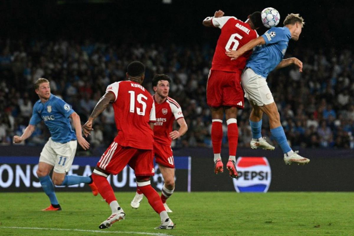 Arsenal's Brazilian defender #06 Gabriel and Napoli's Belgian midfielder #11 Kevin De Bruyne jump to head the ball during the UEFA Champions League - League Phase, Matchday 1 - football match between Napoli and Arsenal at the Stadio Diego Armando Maradona in Naples on September 9, 2026.   Andreas SOLARO / AFP