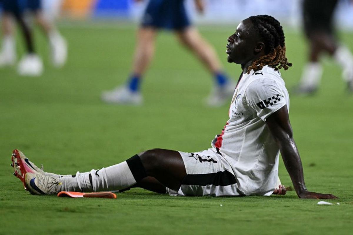 Manchester City's Belgian midfielder #11 Jeremy Doku reacts after losing the FIFA Club World Cup 2025 round of 16 football match between England's Manchester City and Saudi's Al-Hilal at the Camping World stadium in Orlando on June 30, 2025.  PATRICIA DE MELO MOREIRA / AFP