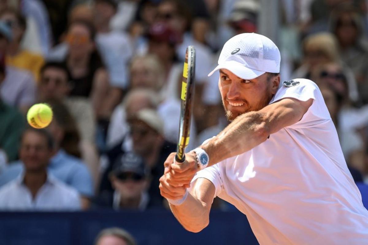 Belgium's Raphael Collignon returns the ball to Greece's Stefanos Tsitsipas during their men's singles final match at the Swiss Open tennis tournament in Gstaad, on July 19, 2026.  Fabrice COFFRINI / AFP