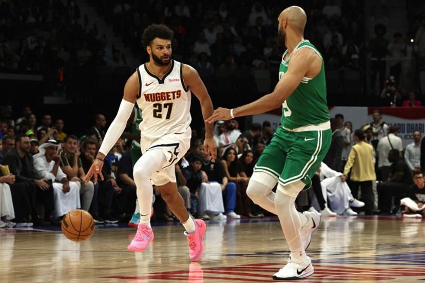 Denver Nuggets' guard #27 Jamal Murray fights for the ball with Boston Celtics' guard #09 Derrick White during the NBA Preseason game between the Denver Nuggets and the Boston Celtics at the Etihad Arena in Abu Dhabi on October 4, 2024.  Fadel Senna / AFP