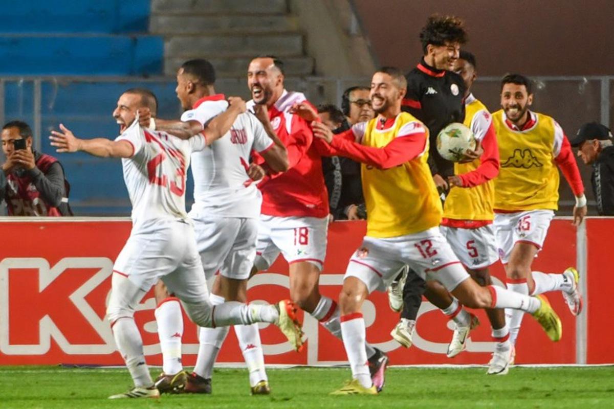 Tunisia's forward #11 Seifeddine Jaziri celebrates with his teammates after scoring his team's first goal during the FIFA World Cup 2026 Africa zone qualifiers group H football match between Tunisia and Malawi at Hammadi Agrebi Stadium in Tunis on March 24, 2025.  FETHI BELAID / AFP