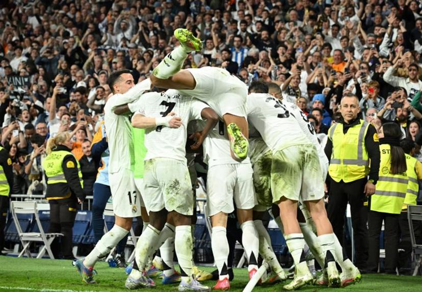 Real Madrid's players celebrate after French midfielder #14 Aurelien Tchouameni scored his team's third goal during the Spanish Copa del Rey (King's Cup) semi-final second leg football match between Real Madrid CF and Real Sociedad at the Santiago Bernabeu stadium in Madrid on April 1, 2025.  JAVIER SORIANO / AFP